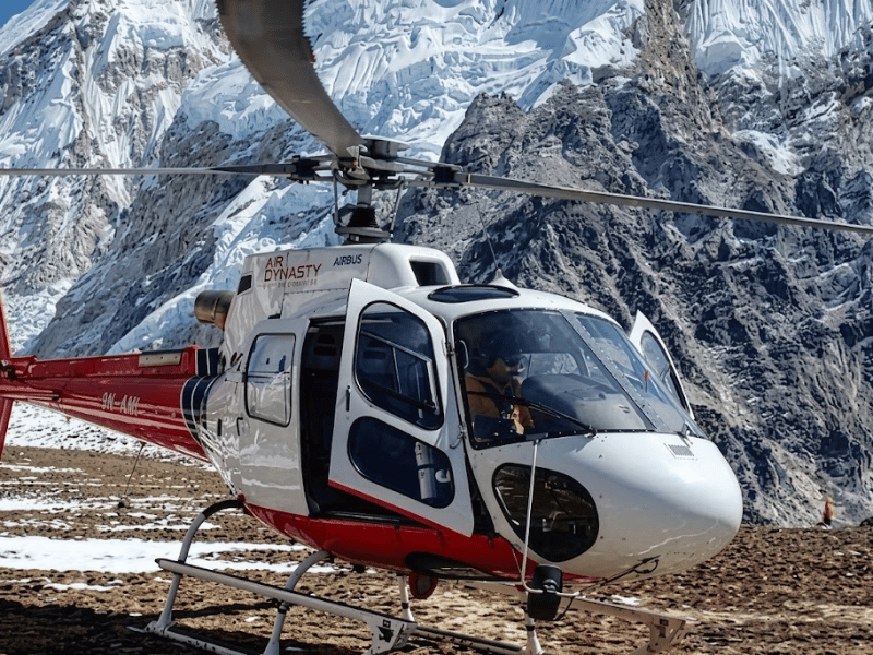 Helicopter landing at Kala Patthar with Mount Everest behind